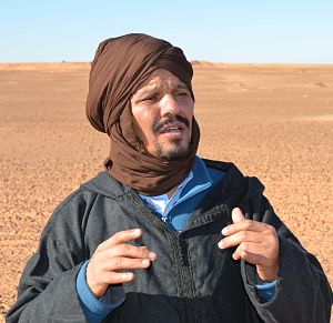 Beisat explains Morocco's Wall (in background) during 2014 visit to Western Sahara