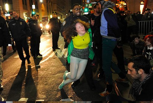 Image of Cecily McMillan being arrested as the NYPD clears Zuccotti Park during a six-month memorial celebration of the Occupy M