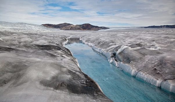 As global warming melts Greenland's massive ice cap, its surface exposes centuries of soot and ash, becoming ever darker and melting ever faster -- just one of myriad vicious climate change circles.