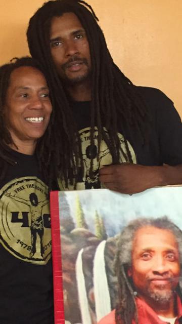 Debbie Africa with son Mike Jr. and photo of still imprisoned husband/father Mike Africa Sr. LBWPhoto