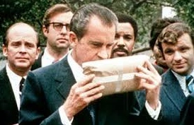 Nixon sucks down some of the aroma from a package of confiscated pot at the start of his Drug War