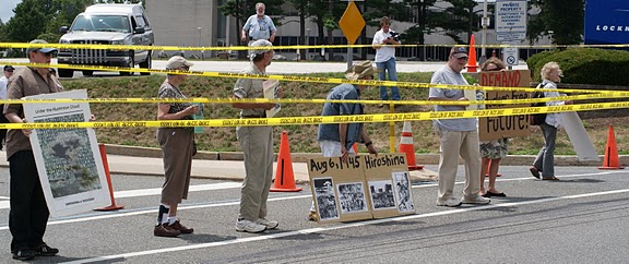 Protesters ran crime scene tape across the Lockheed Martin entrance before being busted (photos by Brandywine Peace Community)