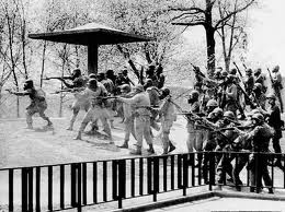 Ohio Guardsmen firing live ammunition at peaceful, unarmed Kent State U. student demonstrators in 1970