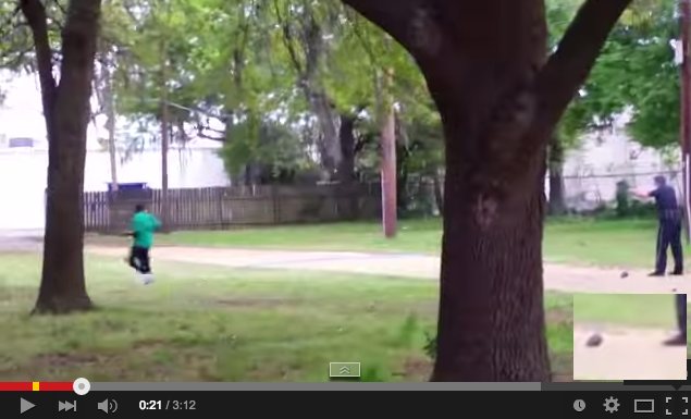 Officer Slater, back at his shooting spot, bends over to pick up something (screen grab #4), and earlier image of a dropped object beside Slater's foot as he's firing (screen grab #5)